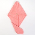 Detailed close-up of pink coral fleece hair towel with a cute bear button closure - Light Pink