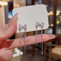 Silver bow earrings with tassels and sparkling zircon stones on an elegant display card - Silver Bowknot Tassel Earrings