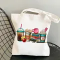 White canvas tote bag featuring teacher fuel theme with books and coffee cup print - Style C16