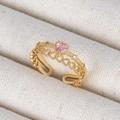Macro view of 18K gold hollow heart ring featuring a pink heart gem and zircon details - Pink Heart Chain Gold Style (Style 12 Gold)