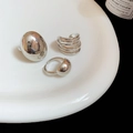 Poliertes silbernes Ring-Set im minimalistischen Stil auf weißem Teller mit Kerze - Stil 2 (3er-Set) / Silber
