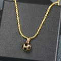 Close-up of golden soccer ball pendant on black leather box with metallic chain - Box Chain Soccer / Gold