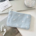Detail of denim star print coin purse with silver zipper on a lifestyle desktop background - Light Blue