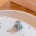 Mini acetate hair claw clip in mint blue with black and white speckles on a ceramic plate - Mint Black White Floral