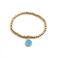 Minimalist gold beaded elastic bracelet featuring a blue enamel smiley face charm - Blue Enamel Smiley