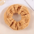 Orange-brown chunky waffle knit scrunchie displayed on a beige plate for hair styling - Yellow