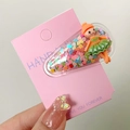 Cute kids hair clip with pink sequins and a tiny ballerina doll in a green dress - Dancing Girl
