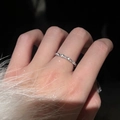 925 silver wavy ring with small stones shown on model finger in elegant dark setting - Silver Twisted Wave (JZ1078)
