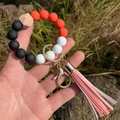 Silicone bead keychain wristlet with orange beads and faux leather tassel detail - Orange