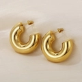 Polished golden hollow C-shape chunky hoop earrings on silk background - Gold Shiny Style