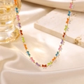 Golden butterfly necklace with colorful enamel charms on elegant silk background - Colorful Enamel Butterfly