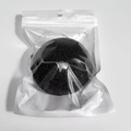 Single black round konjac facial sponge in clear poly bag for deep facial cleansing - Black Hemispherical