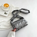 Chic silver grey quilted puffer crossbody bag with wide shoulder strap on white fabric - Silver