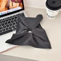 Dark grey bow-shaped scrunchie accessory displayed on an office desk with laptop and coffee - Dark Grey Scarf