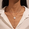 Double-layered golden necklace with white enamel flower and pearl drop pendant on model - Gold-Tone Double-Layer Artificial Pearl Enamel Flower Y-Necklace (KC Gold 4060)