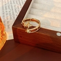 Detailed close-up of a vintage golden starburst open ring on a wooden jewelry box - Single Layer Four-pointed Star Style / Ring-Gold-Coffee