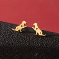 Cute gold stainless steel puppy stud earrings with heart cutout on red and black surface - Gold
