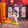 Detailed close-up of a Chinese style resin figurine in Hanfu holding a small yellow bird - Chen Yuanyuan