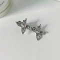 Silver liquid metal bow hair clip with central rhinestones on a white textured surface - Silver White Rhinestone Butterfly