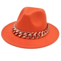 Close-up of orange wool fedora hat featuring a chunky gold metal chain decoration - Orange