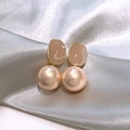 Macro shot of French vintage pearl earrings with champagne luster on grey satin fabric - Rose Gold Resin Enamel Pearl Style (A1327)