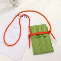 Detail of green knitted phone bag with vertical ribbed texture and orange shoulder strap - One Size / Grass Green Bag + Orange Rope