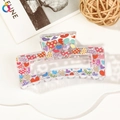Detailed macro view of acrylic hair claw clip with colorful heart pattern prints - 8.5cm Heart Print - Style G Transparent Base