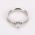 Macro shot of silver six-prong set round solitaire ring with pave diamond band - US 6 / Steel