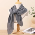Detail of grey pleated square scarf tied on a mannequin in a cozy home setting - Dark Gray
