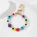 Colorful evil eye beaded keychain with gold metal clasp on a textured white background - Multi-color Flat Beads