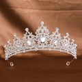 Detailed shot of a silver bridal crown with symmetric rhinestones on brown silk fabric - Silver White Rhinestone