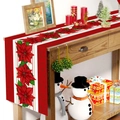 Kersttafelloper met rode kerstster patronen op een sfeervol houten tafeldecoratie - Kerst Rood Kerstster