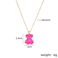 Pink resin bear pendant necklace with gold chain and star details on white background - Rose Red Cross Chain