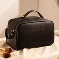 Elegant black leather checkered makeup bag with gold zipper on silk background - Star-dai Black - Double-zip Bag
