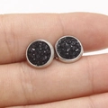 Detailed view of 8mm black star-dust earrings held in hand to show actual scale - Black (12)