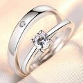 Macro shot of silver couple rings featuring a solitaire diamond and an accent stone band - Men / One Life One Love