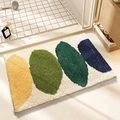 Absorbent cream bathroom mat with colorful leaf pattern in a cozy shower setting - Lemon Beige
