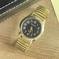 Detail of quartz watch featuring golden elastic steel band and black numeric dial - Men's Watch / Gold Band Black Dial