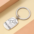 Macro detail of silver Pisces zodiac keychain with engraved Peixes text on metal tag - Pisces