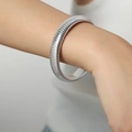 Silver Tubogas flexible stretch bracelet in stainless steel shown on model wrist - 12MM Wide / Steel