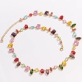 Macro detail of gold-plated necklace featuring multi-color zircon stones in rectangular claws - Necklace / Gold