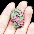 Oval natural Ruby Zoisite gemstone cabochon with green and red mineral patterns - Ruby Zoisite