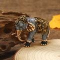Macro detail of a luxurious gold and grey elephant brooch with fine enamel craft - Elephant - KC Gold Coffee