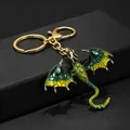 Macro detail of golden dragon keychain with green enamel inlay and rhinestone accents - Green