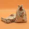 Linen drawstring pouch with red floral print for jewelry or sachet storage - Rose Blossom Brooch