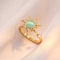 Detail of a gold sun ring with a green cat-eye gemstone on beige silk fabric - Adjustable Open Sunflower Ring