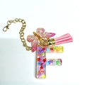 Letter F keychain with colorful heart sequins, pink butterfly charm, and gold hardware - Letter F