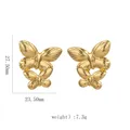 Detailed macro view of 18k gold butterfly earrings with wings texture and polished finish - Double Layer Butterfly Earrings