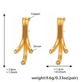 Dettaglio di orecchini geometrici in rame con zirconi e finitura dorata lucida - Oro