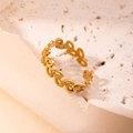 Elegant gold titanium steel leaf ring with open adjustable band on a beige stone base - Leaf Gold 76
